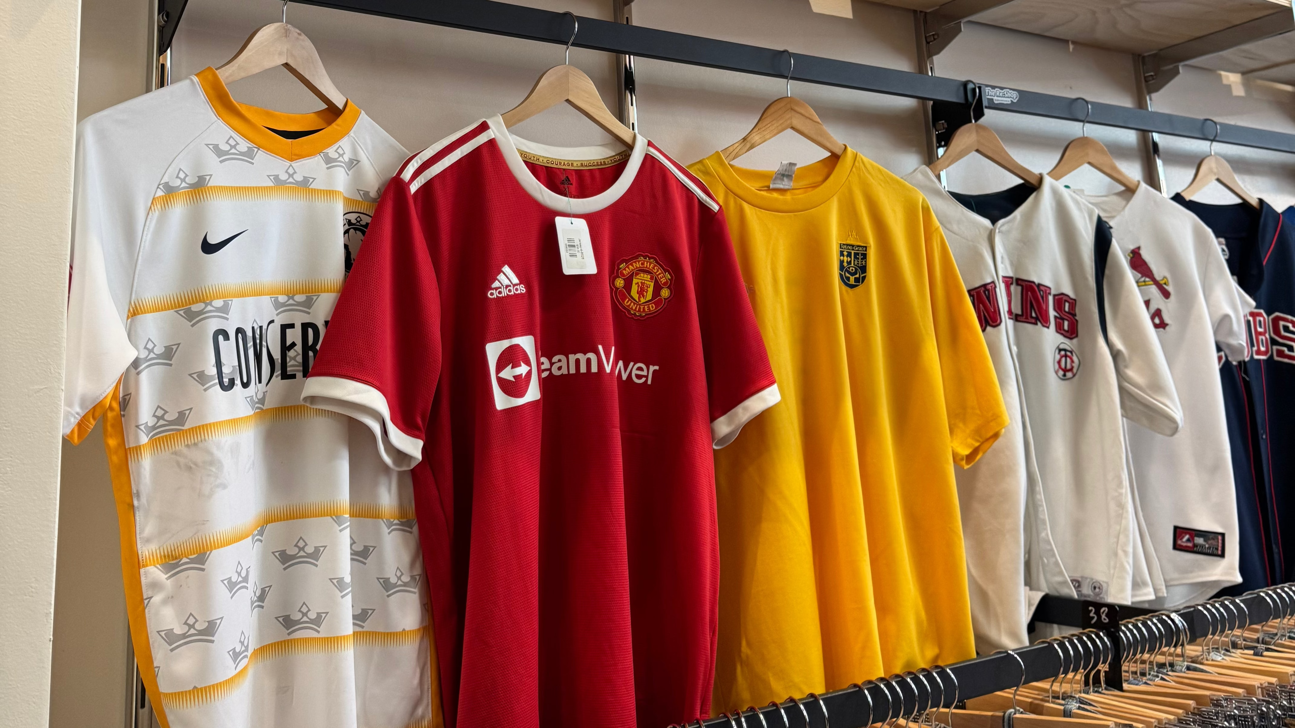 Shelves with sports jerseys and collectibles in a store setting